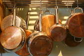 Copper pots hanging from a pot rack