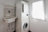stackable washer and dryer unit in a bathroom