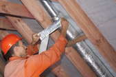 a man taping ductwork