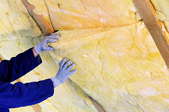 Blanket insulation fitted between the studs in the attic.