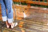 A wood deck with a pressure washer. 
