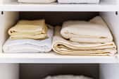 A neatly stacked linen closet.