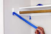 peeling off blue painter's tape from corner of closet