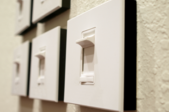 row of light switches on a wall
