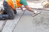 Worker leveling out concrete