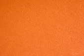 A close up of orange peel texture on a painted wall.