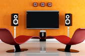 modern room with curvy chairs and speakers around a television