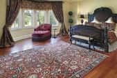 a well appointed bedroom with a Persian rug