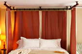 A Ceiling Mounted, Plumbing Pipe Canopy Bed.