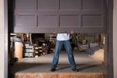 man lifting a garage door