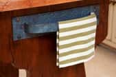 A kitchen towel hanging on a vintage handle