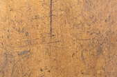 A scratched old wooden table surface.