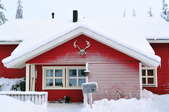 red house in winter covered in snow