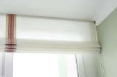 white Roman blind with vertical stripe