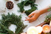 hand with wreaths and candles