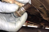 hand holding a drain plug removed from the car engine