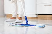 A mop cleaning a kitchen floor. 