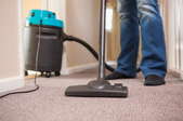 A man cleans dirty carpet in a room.