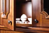 open wooden cabinet door with bowls inside