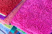 A stack of colorful shag rugs. 