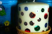 A crafter's sequined, white pillar candle.