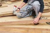 a man installing wooden flooring