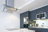 clean, modern kitchen with large ceiling extractor fan