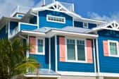 brightly colored beach house with white and peach trim