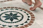 Feet on mosaic tiles