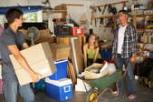 A family of three organizing a garage. 