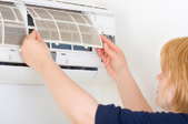 women removing front of a heat vent