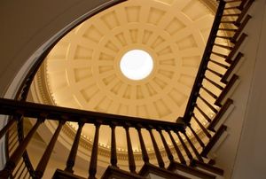 view looking up a staircase with a handrail