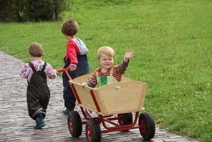 children playing with wooden wagon