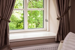 bay window with sitting bench and brown curtains