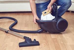 A man works on a vacuum.