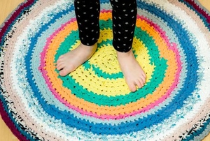 Someone standing on a round, fabric rug
