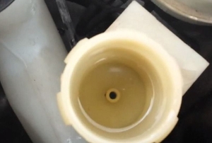 A half full clutch master cylinder reservoir.