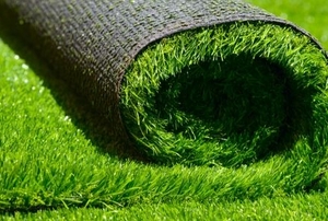 artificial turf grass rolled up on an astroturf lawn