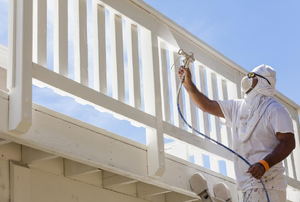 Person painting a balcony railing
