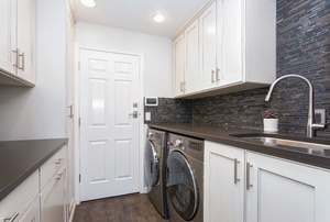 A laundry room with a washing machine.