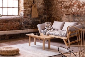bohemian wabi sabi living space with exposed brick and large window