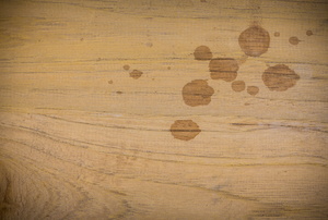 Wood with some round oil stains on it. 