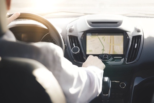 a person sitting in a car, looking at the Car Dashboard