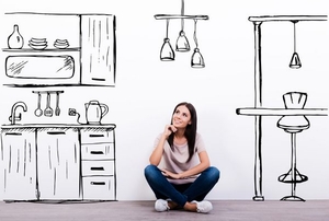 A woman sitting in a cartoon drawing of a kitchen.