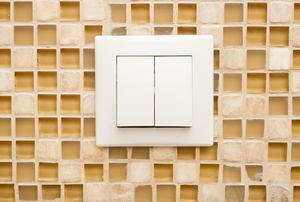 A light switch on a ceramic background.