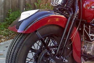 the front wheel on a red motorcycle