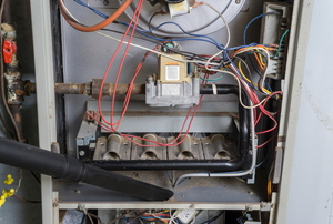 An inside look at the back of a gas furnace.