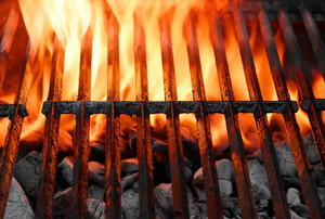 A grill grate with flames blazing from below.