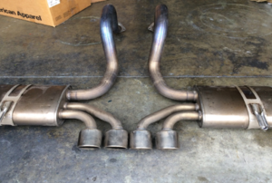 automobile exhaust system laying on a shop floor