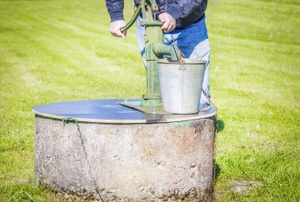 A man uses a well.